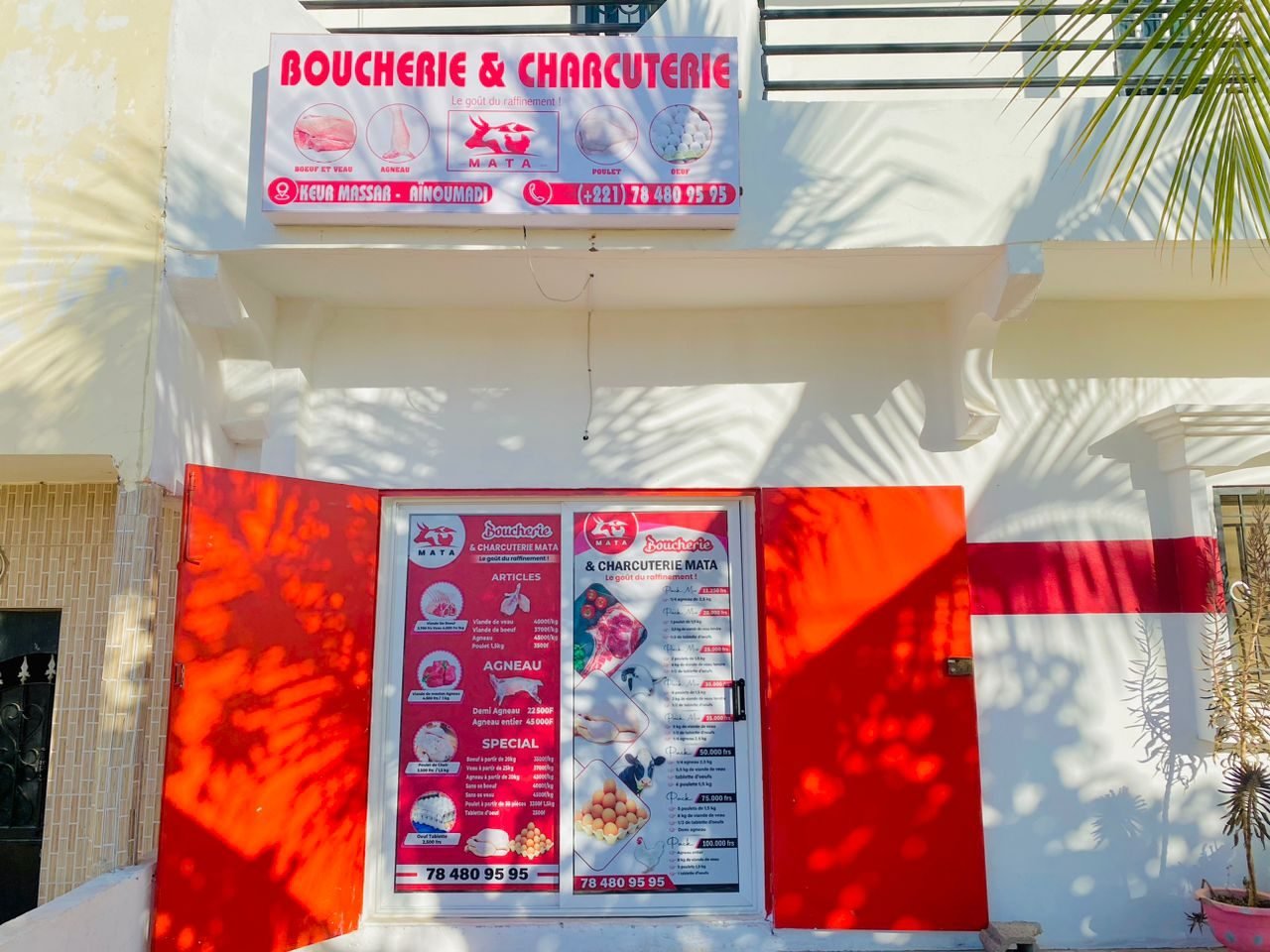 Devanture de la boucherie MATA Keur Massar, cité Aïnoumadi, portes rouges et enseigne MATA